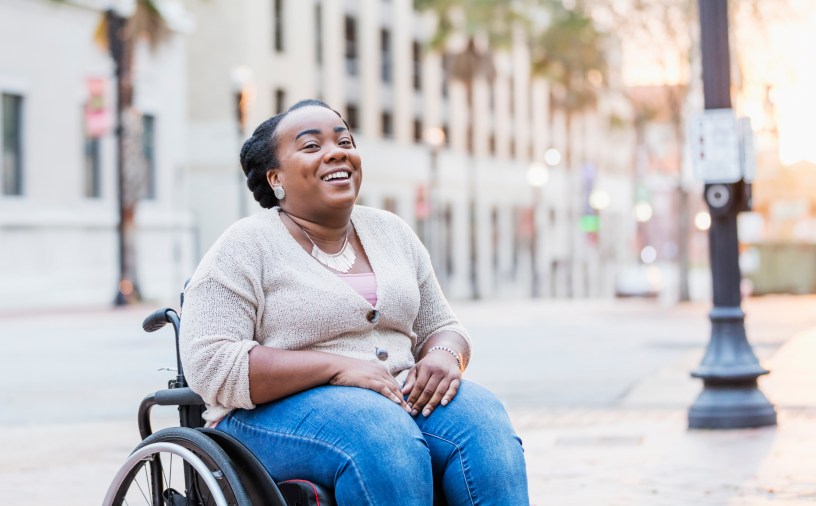 Headline image shows a Black wheelchair user laughing outside.